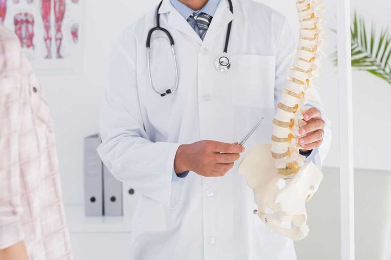 A chiropractor gently adjusting an adult patient's back in a calm clinic setting.